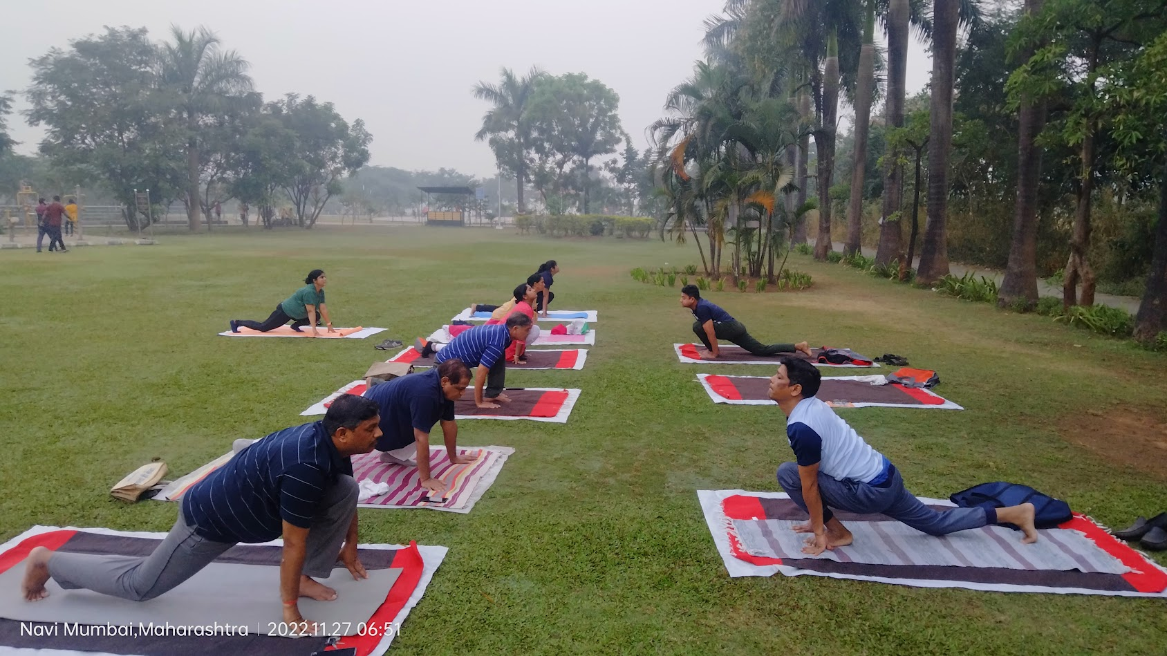 Students practicing yoga outdoors under Sandeep Vyapari's guidance